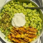Bowl filled with green goddess salad and nut free green goddess dressing with grilled chicken